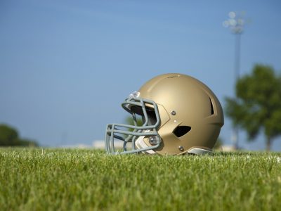 Low angle view of football helmet on grass field