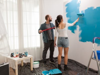 Painting wall using roller paint brush
