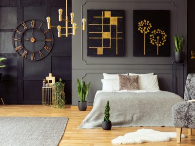 Real photo of golden accents, clock, paintings, plants and doubl