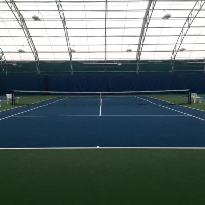 Indoor tennis court at a sports complex.