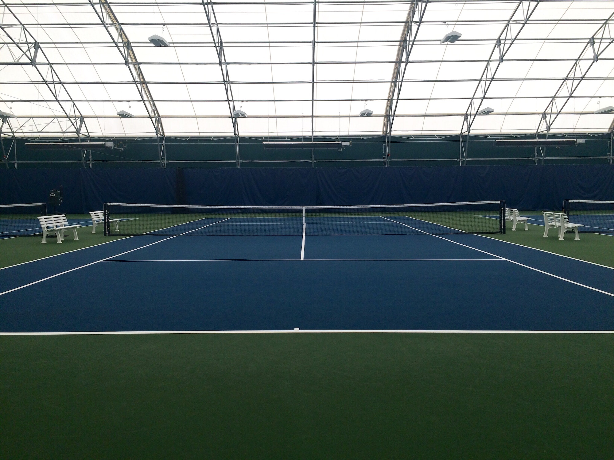 Indoor tennis court at a sports complex.