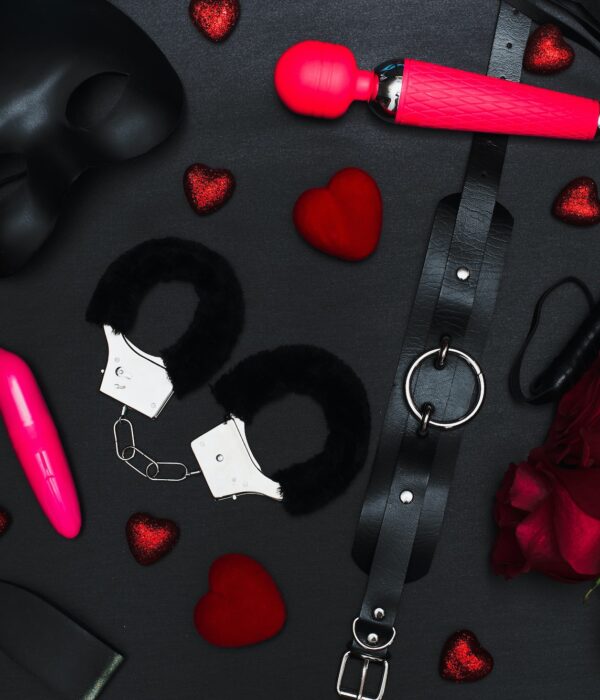Set of adult toys on a dark background with red roses